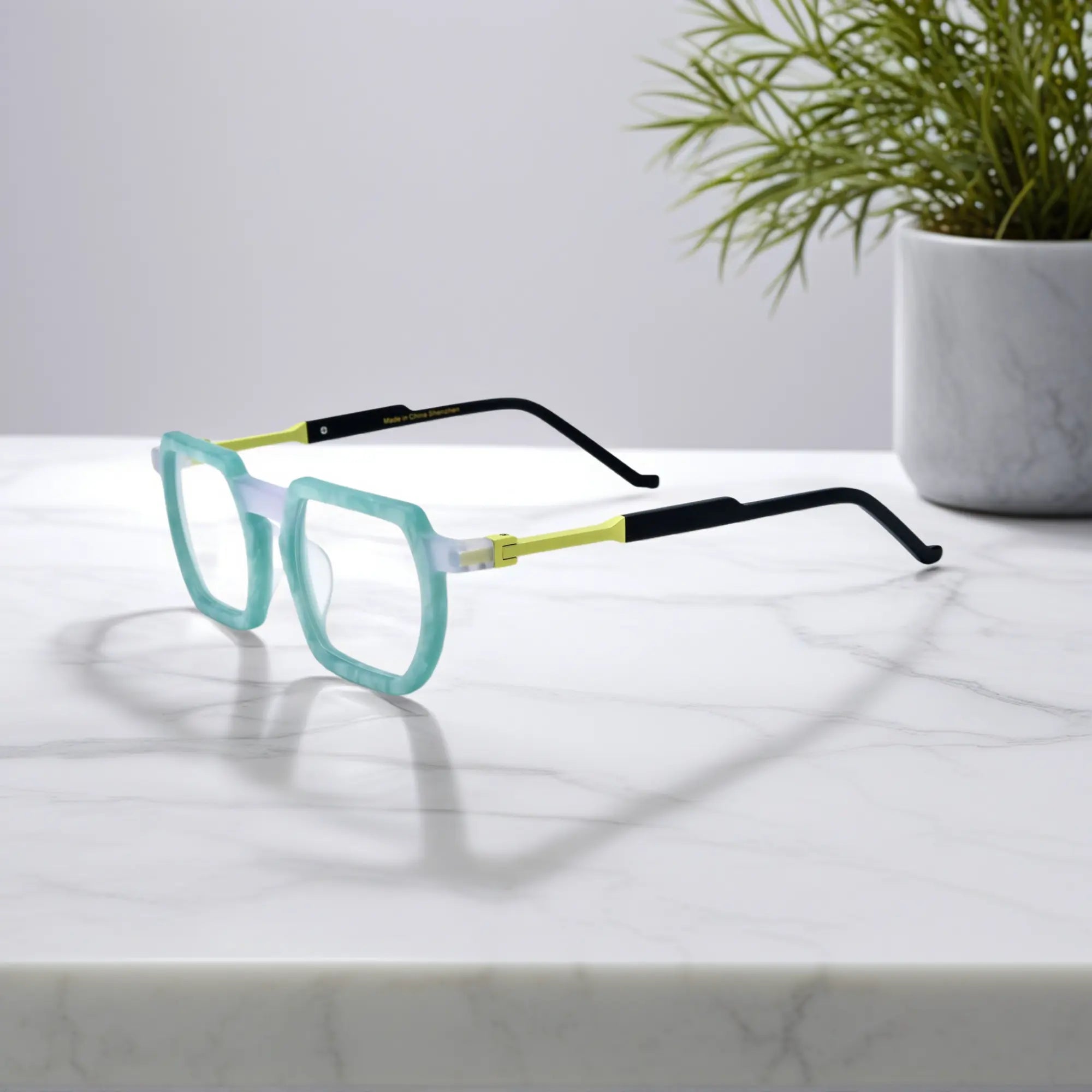 Side profile highlighting smooth marble blend of pale green and white with polished geometric temples
